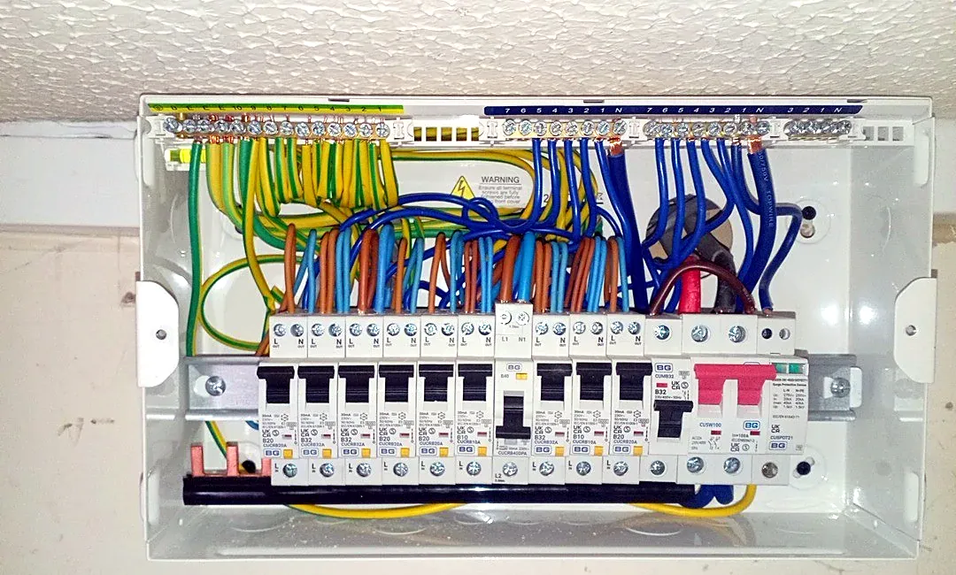 Inside a consumer unit: RCBO breakers, surge protection and neat wiring to the earth and neutral bars