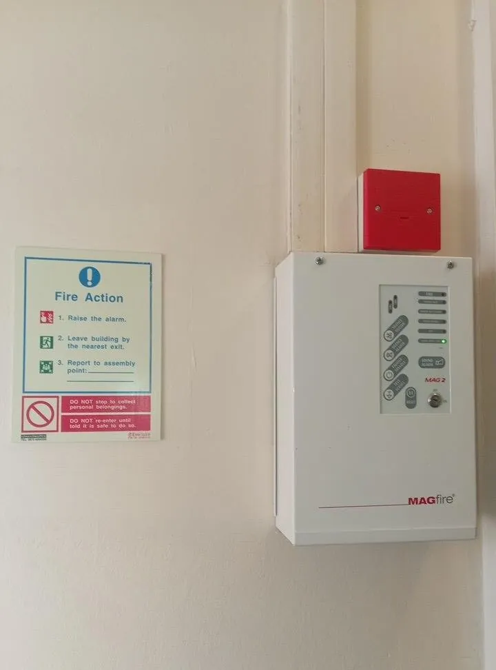 Fire alarm control panel and fire action notice checked during a fire risk assessment